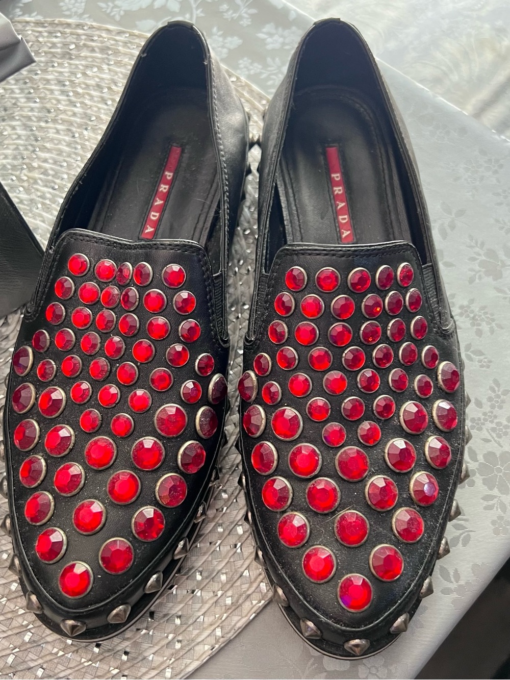 Prada Black Leather Slip-Ons with Red Gem Studs and Silver Cone Trim